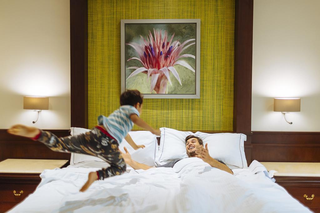 Hotel Occidental At Xcaret Destination Playa del Carmen Exterior foto A child jumps on a bed.